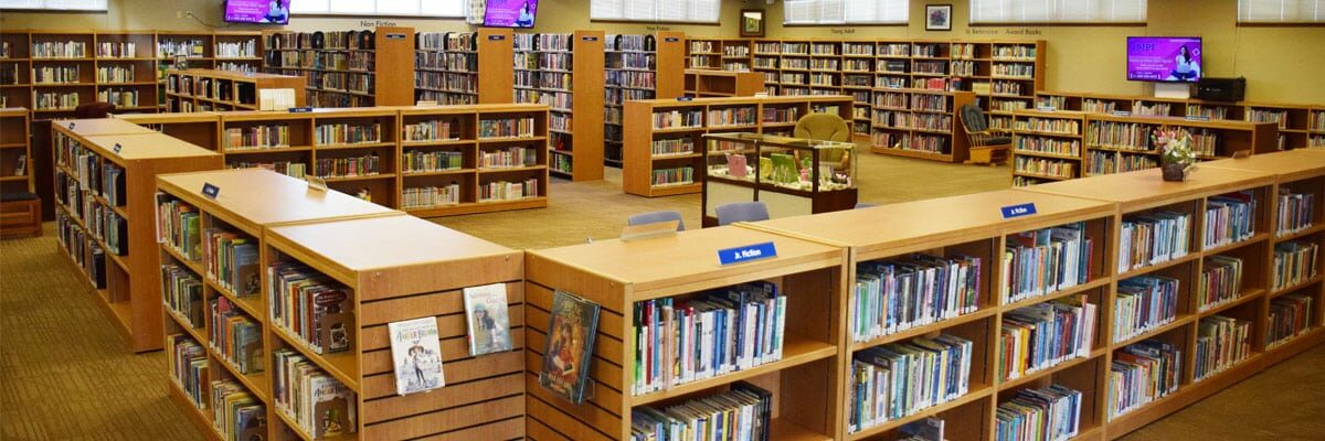 A panoramic view of a library with many bookshelves.